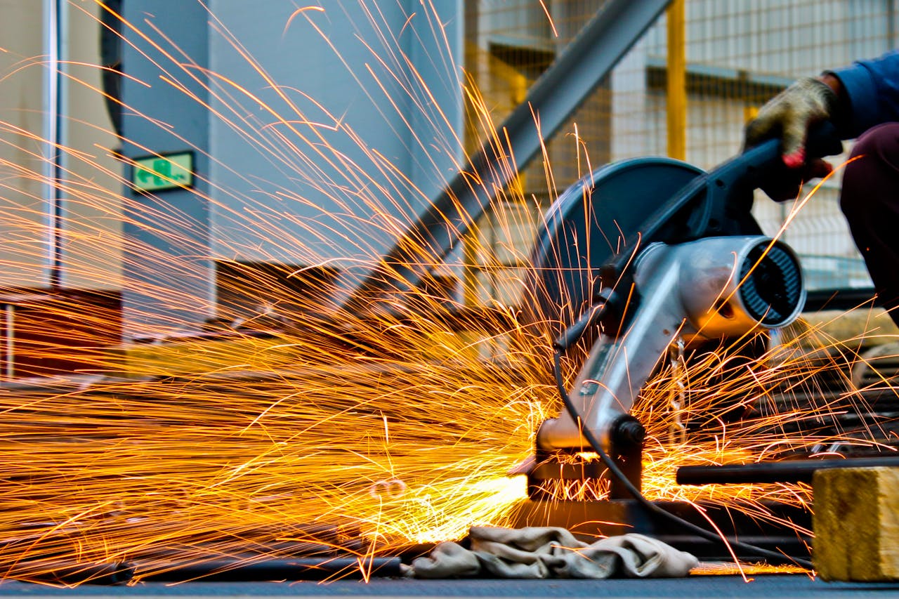 The Art of Drawing Readers In: Your attractive post title goes here A worker operates a grinder cutting metal, creating a vibrant display of sparks in an industrial setting.