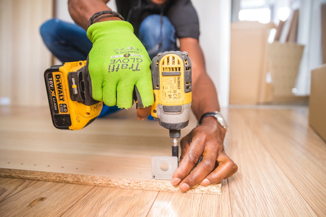 Crafting Captivating Headlines: Your awesome post title goes here Man using a power drill for home improvement on a wooden floor with precision.